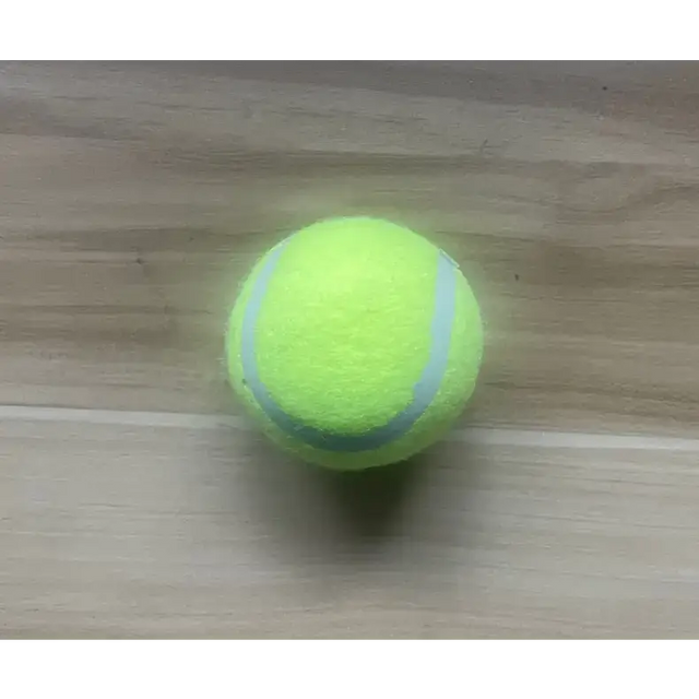 A bright yellow tennis ball with two light gray curved stripes.