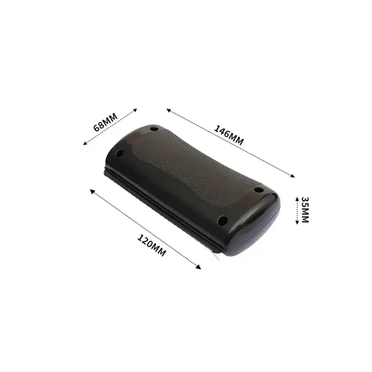 Black plastic handheld device with textured grip surface and rounded edges.