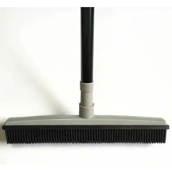 Black and gray floor brush with a long handle, featuring dense bristles for effective cleaning.