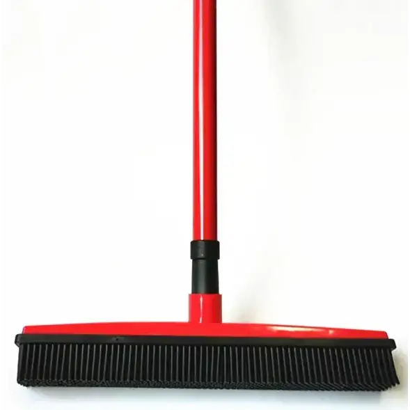 Red and black floor sweeper with a long handle, flexible bristles for effective cleaning.