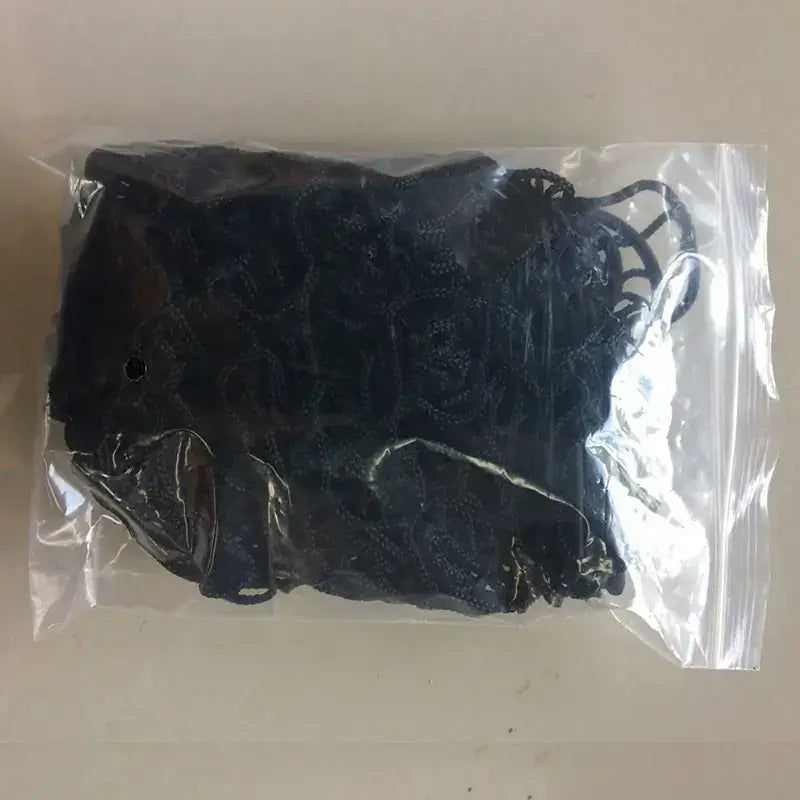 Black lace bralette in a clear plastic bag.