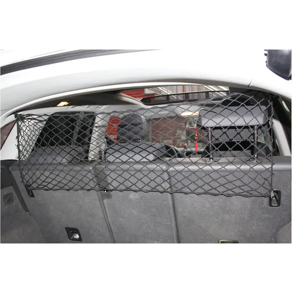 Black mesh cargo net designed to secure items in a car’s trunk.