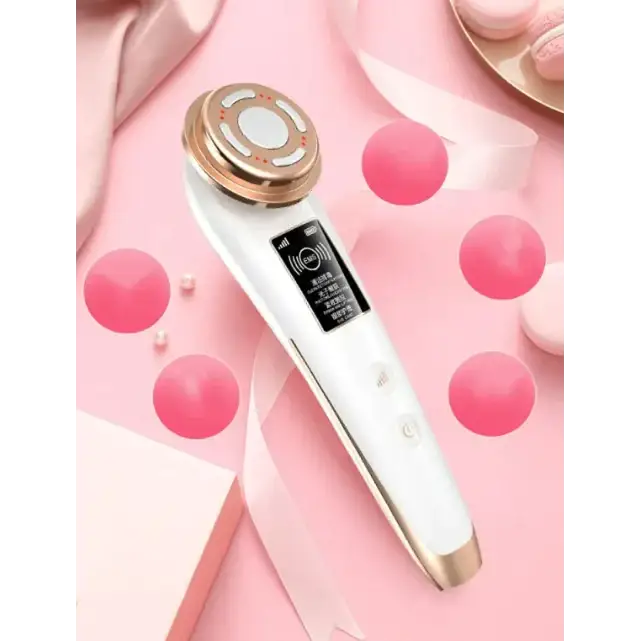 White and gold facial care device with a sleek, ergonomic design featuring a circular treatment head and digital display.