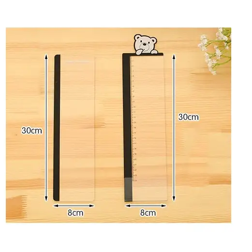 Clear plastic ruler with black edge and a cute white bear design at the top.