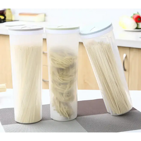 Three transparent cylindrical storage containers with white lids, each holding different types of dried pasta.
