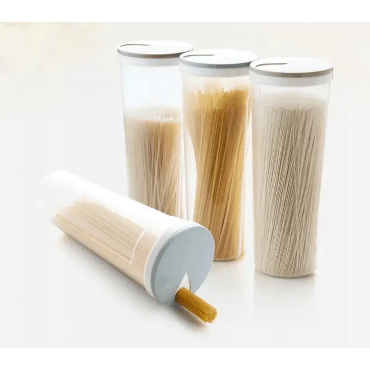 Transparent cylindrical pasta storage containers with light gray lids, each holding different types of dry noodles.