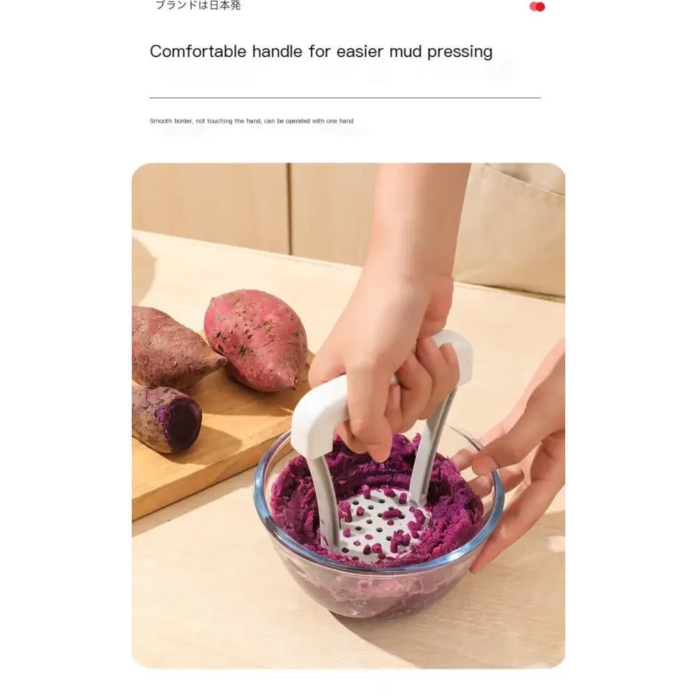 White plastic potato masher with a comfortable handle and perforated pressing head.