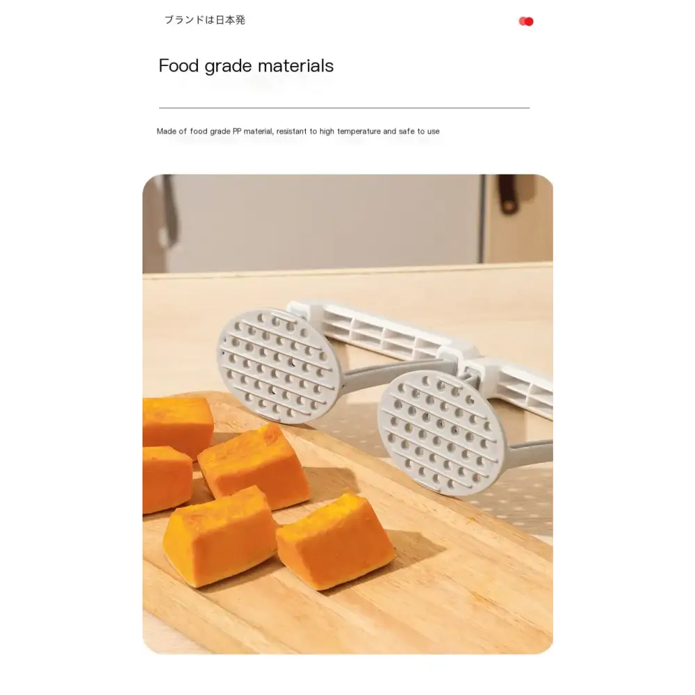 White plastic food-grade potato masher with perforated circular heads and a foldable handle.