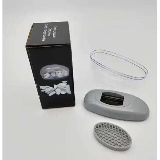 Gray plastic nail clipper with a black cutting blade and an oval-shaped, honeycomb-patterned base.