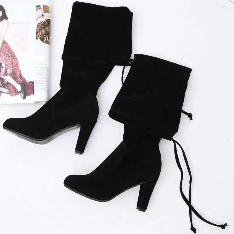 Black suede over-the-knee boots with a high block heel and adjustable drawstrings.