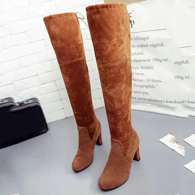 Tan suede over-the-knee boots with a block heel and elastic side panel for a snug fit.