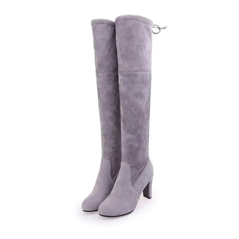 Gray suede over-the-knee boots with a block heel and adjustable strap at the back.