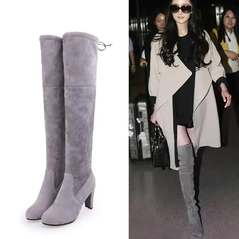 Gray suede over-the-knee boots with a block heel and side zipper.