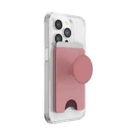 Pink popsockets phone grip with a matte finish and circular base, attached to the back of an iphone.