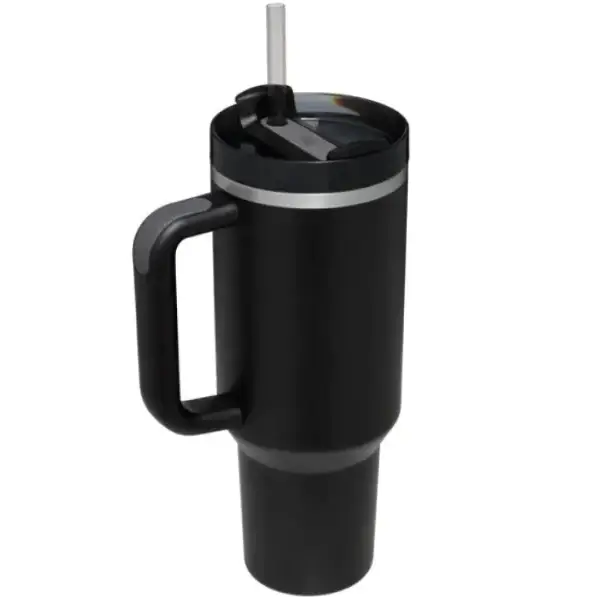 Black insulated travel mug with a sturdy handle, silver rim accents, and a clear straw inserted into its lid.
