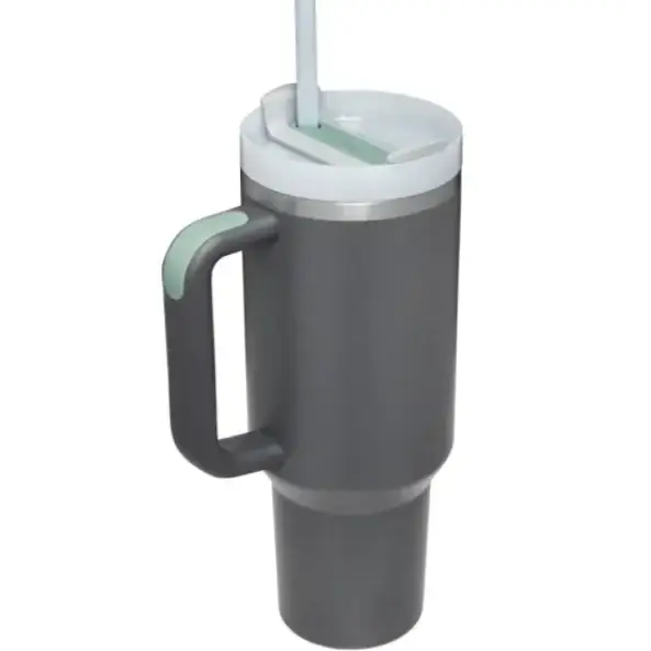 Dark gray insulated tumbler with a white lid, silver rim accents, and a matching handle featuring light green grip details.