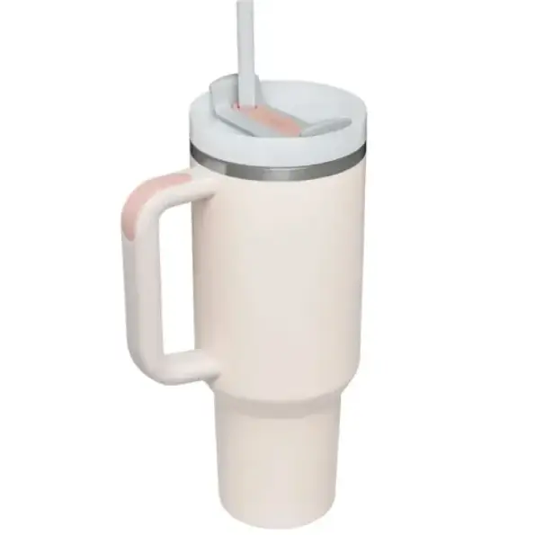 Cream-colored insulated tumbler with a white lid, silver rim, and pink-accented handle.