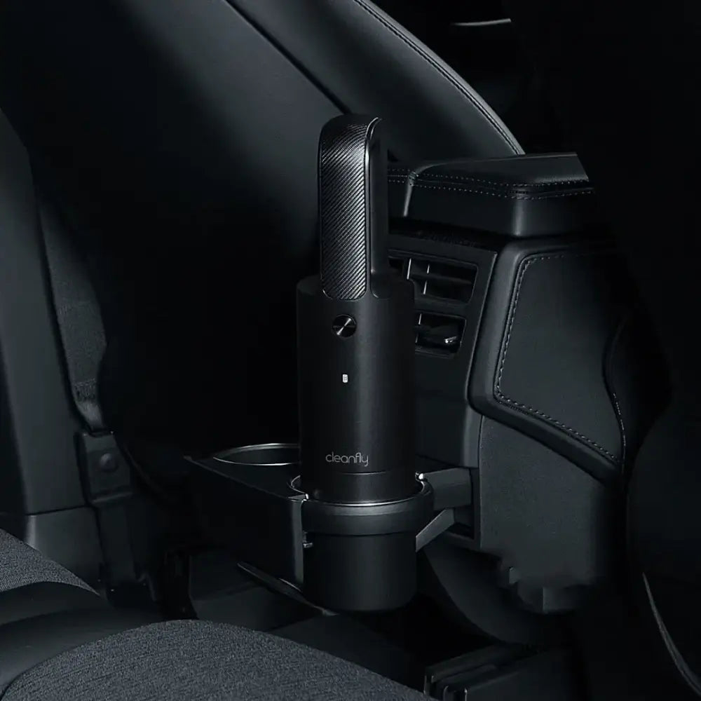 Black carbon-fiber-textured handheld car vacuum with ’cleanfly’ branding