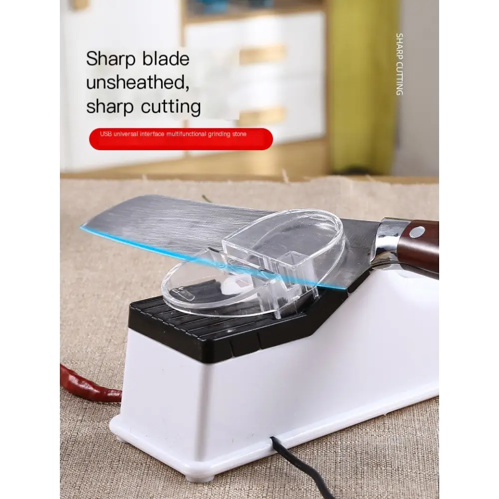 White and black usb electric knife sharpener with transparent protective cover holding a stainless steel blade.
