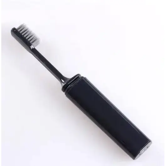 Black electric toothbrush with a sleek, cylindrical handle and soft bristles.
