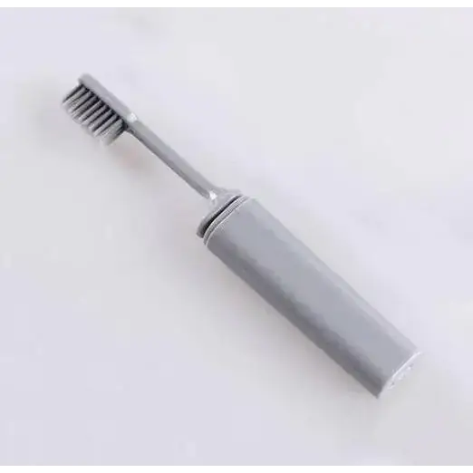 Gray electric toothbrush with a sleek, modern design and metallic bristles.
