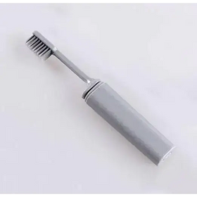 Gray electric toothbrush with a sleek, modern design and metallic bristles.