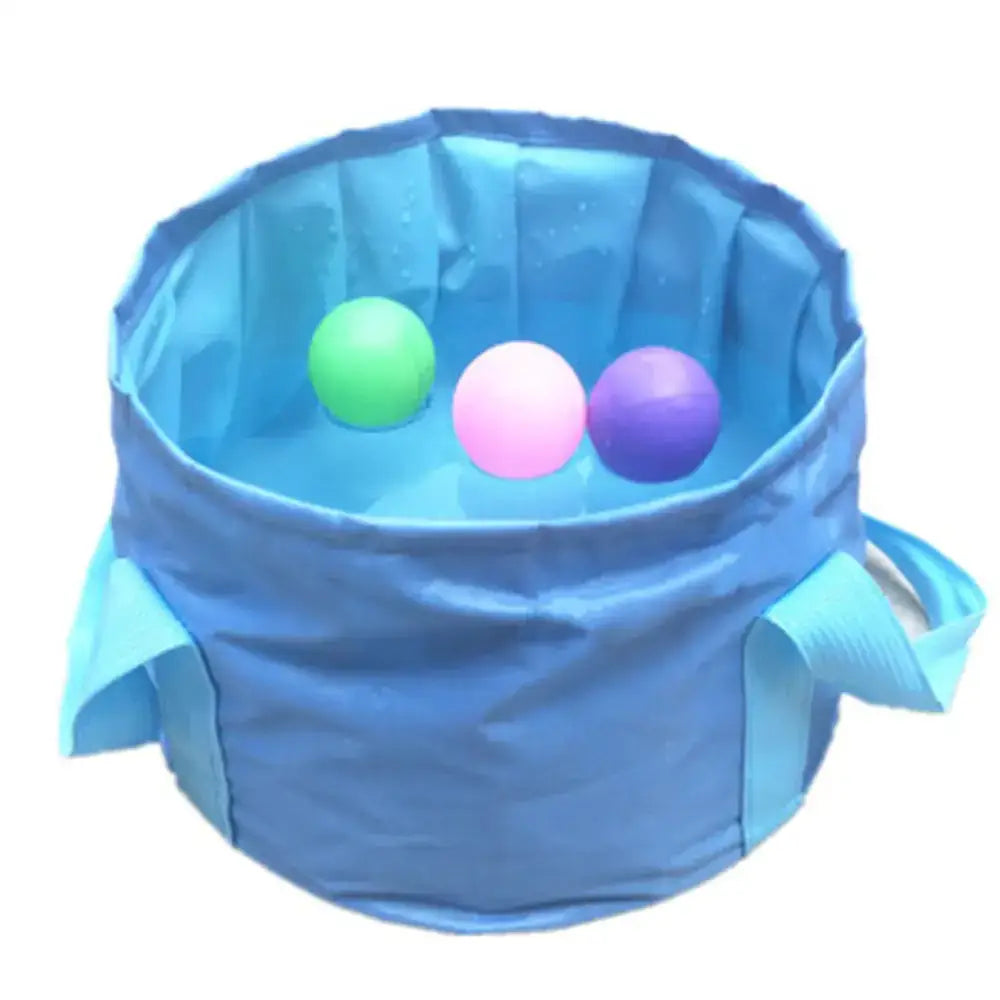 Blue collapsible fabric bucket with three colorful plastic balls inside