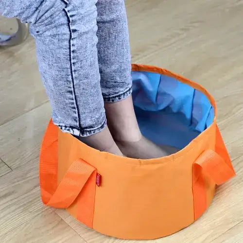 Orange collapsible foot bath with blue interior lining