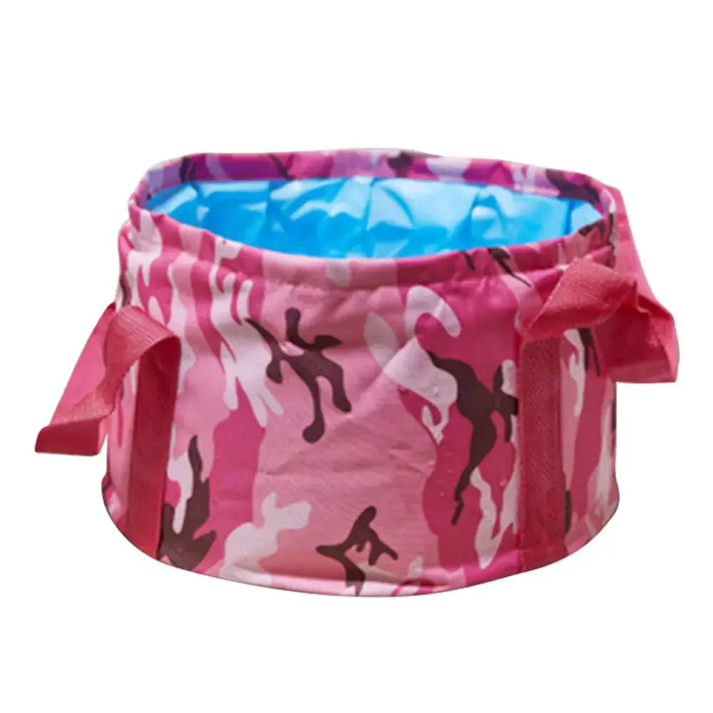 Pink camouflage-patterned collapsible folding wash basin with a blue interior lining and fabric handles.