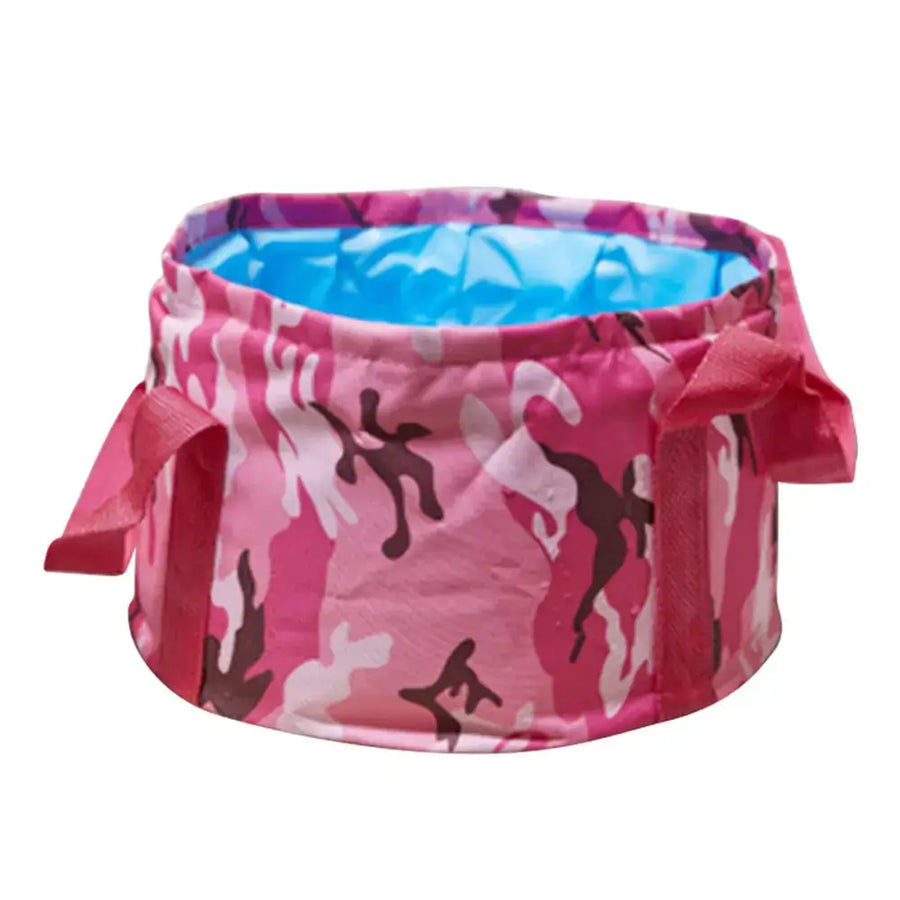 Pink camouflage-patterned collapsible folding wash basin with a blue interior lining and fabric handles.