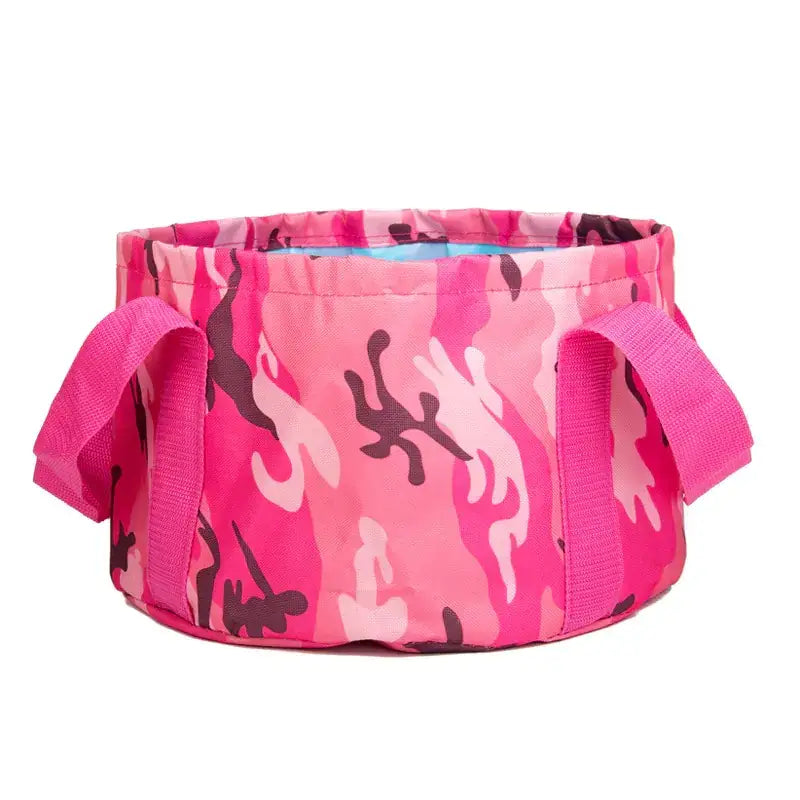 Pink camouflage-patterned collapsible wash basin with fabric handles.