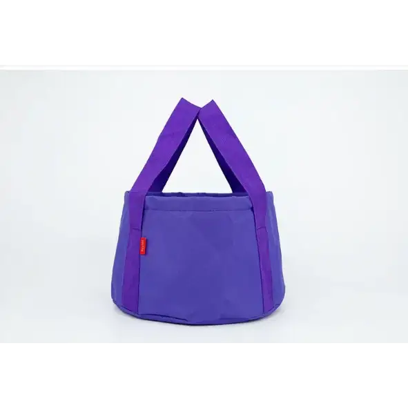 Purple fabric tote bag with matching handles and a small red tag on the side.
