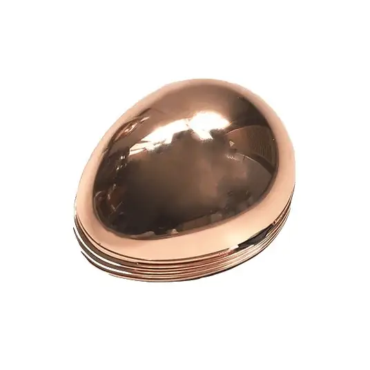 A sleek, copper-colored egg-shaped compact mirror with a reflective surface and layered metallic edges.