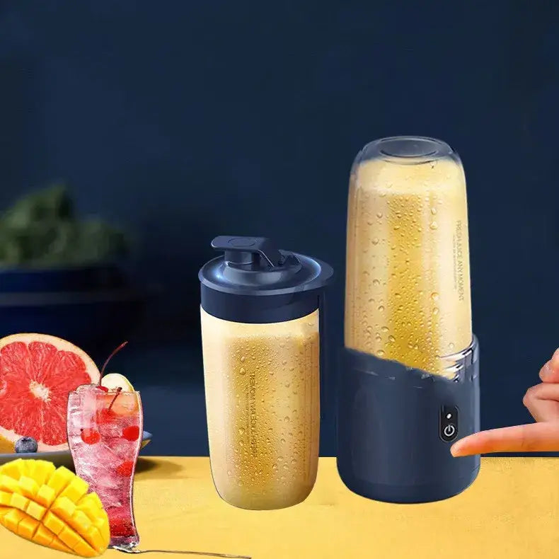Black and transparent handheld blender with a power button on its base, filled with a yellow smoothie.