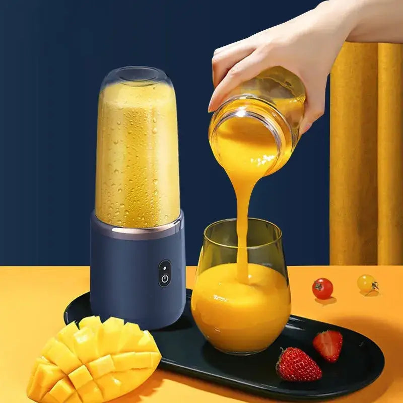 Blue portable blender with transparent blending cup filled with yellow smoothie