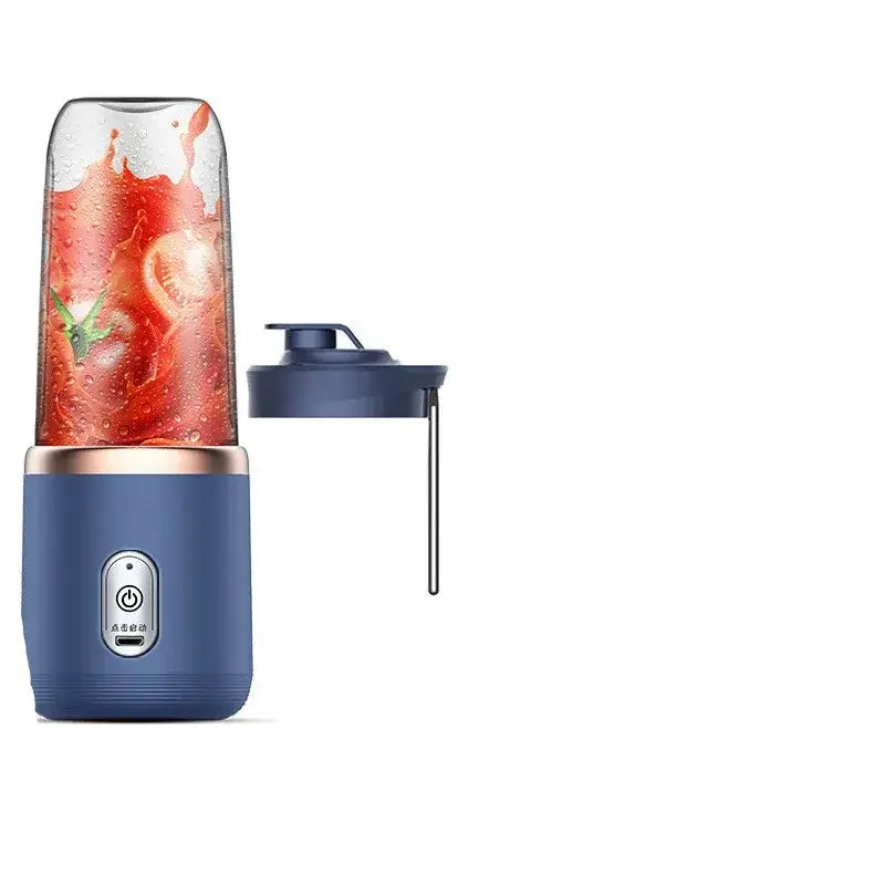 Blue portable blender with a clear glass cup filled with red tomato puree and a matching navy lid.