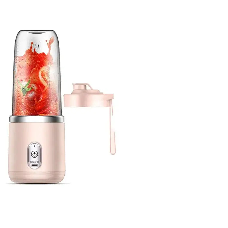 Pink portable blender with transparent blending cup and matching lid, featuring a silver power button on its base.
