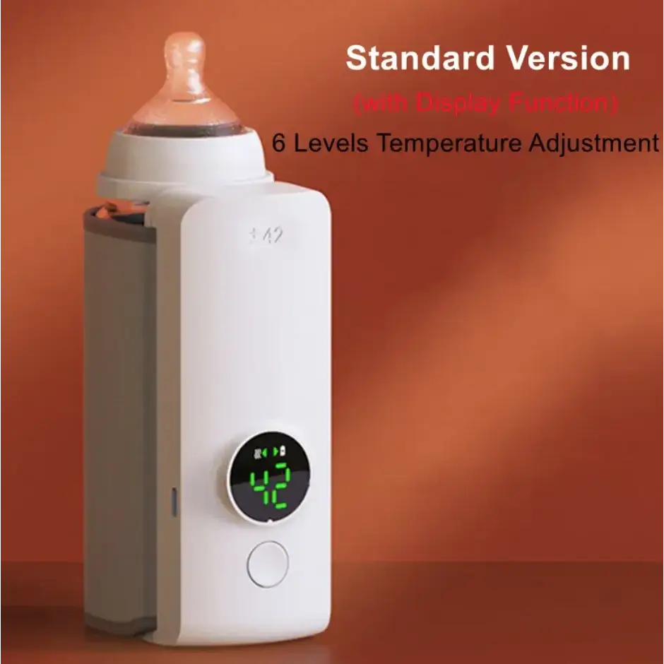 White electric bottle warmer with a digital display showing 42 degrees and a baby bottle inserted into its top.