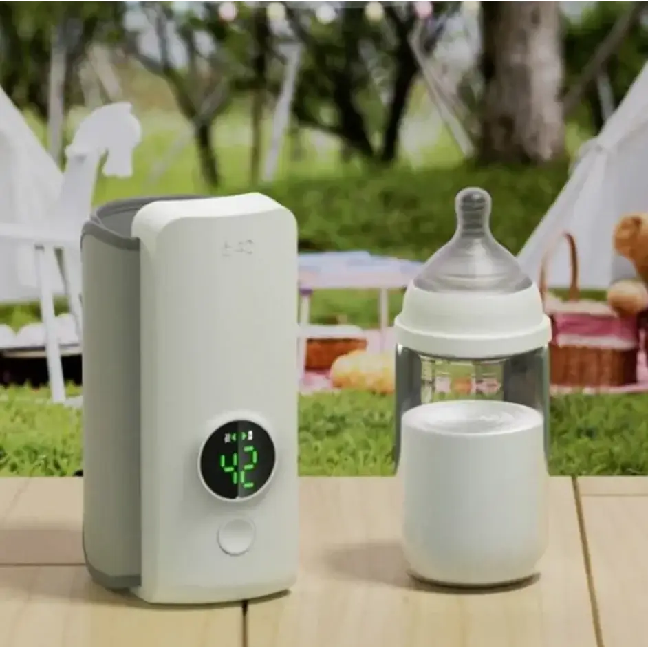 White and gray electric bottle warmer with a circular digital display showing the temperature.