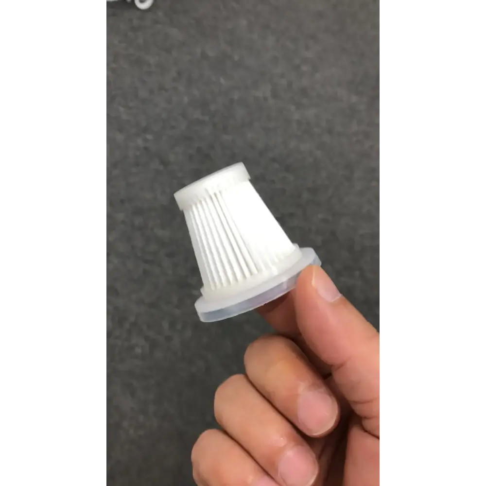 White plastic vacuum cleaner filter with a ribbed interior and translucent base.