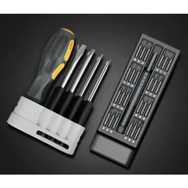 A black and yellow screwdriver with a textured grip, accompanied by multiple precision bits in an organized tray.