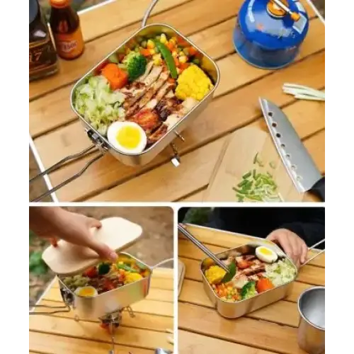 Stainless steel camping bento box with a lid, filled with colorful vegetables and grilled chicken.