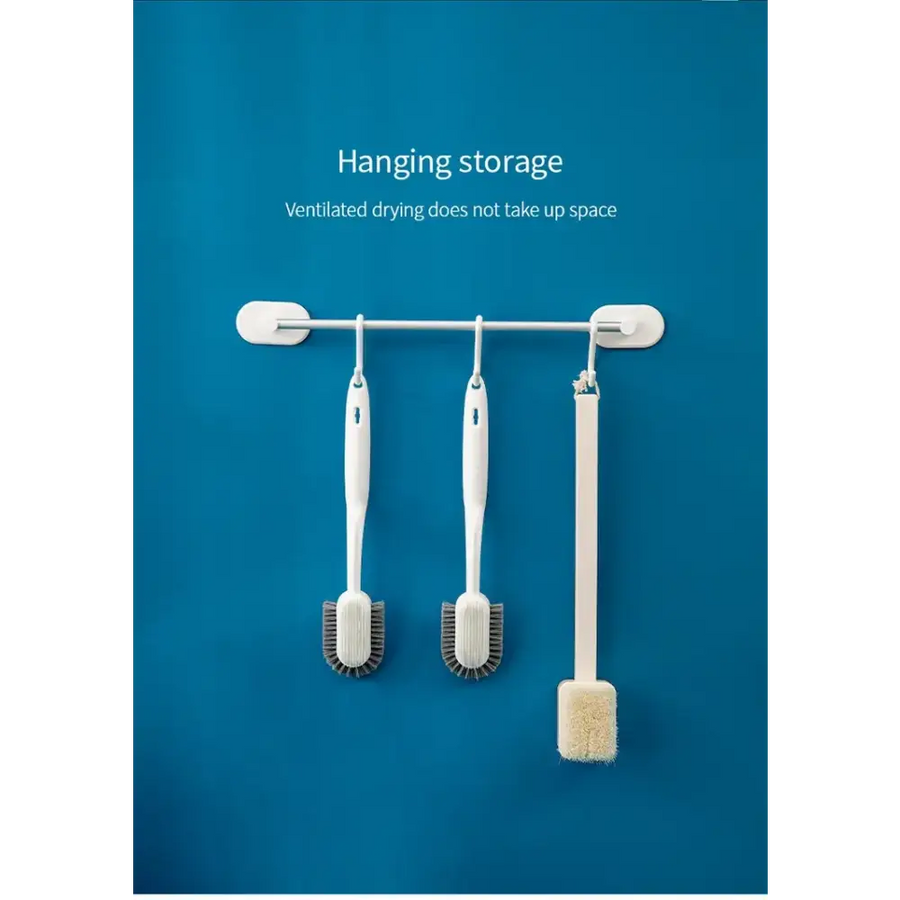 White hanging storage rack with three hooks holding assorted cleaning brushes.