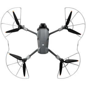 Gray dji mini 3 pro drone with black propellers and silver protective guards.