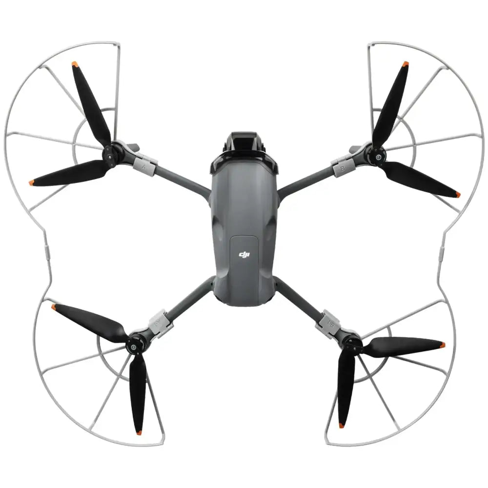 Gray dji mini 3 pro drone with black propellers and silver protective guards.