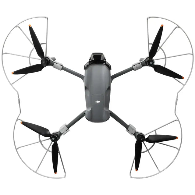 Gray dji mini 3 pro drone with black propellers and silver protective guards.