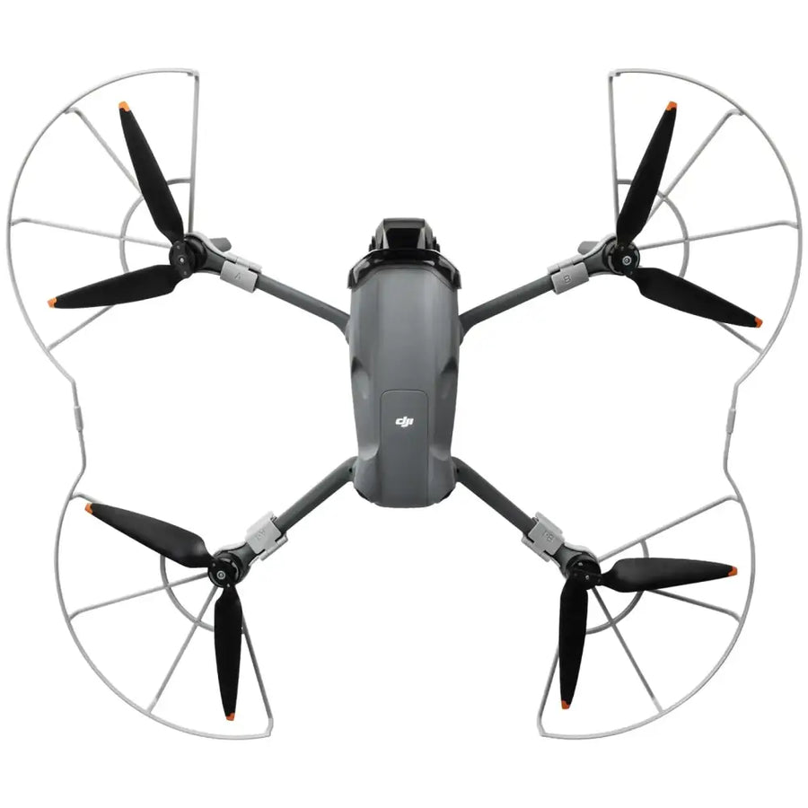 Gray dji mini 3 pro drone with black propellers and silver protective guards.