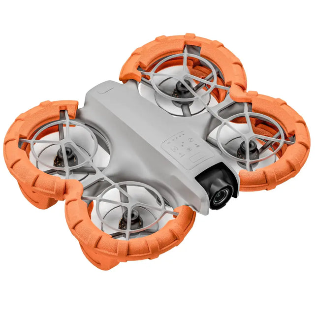 Orange and gray quadcopter drone with rugged, textured protective guards around each propeller.
