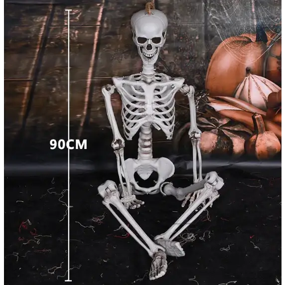 A 90cm tall white plastic skeleton figurine with a pumpkin on its head, sitting in a relaxed pose.