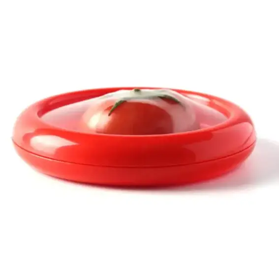 Red plastic tomato slicer with a clear lid and green stem.